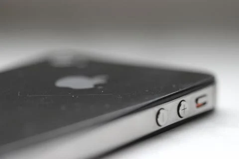 Smartphone Volume Up Button Used iPhone 4 with scratches on Ivory surface Stockfoto's
