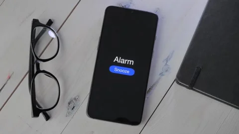 Smartphone where the Alarm Clock starts on the Display. Stock Footage 258138564