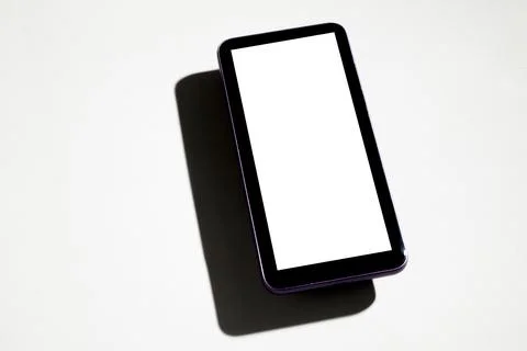 Smartphone with white screen on top of gray table. Cell phone concept. White  Stock Photos
