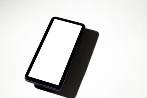 Smartphone with white screen on top of gray table. Cell phone concept. White  Stock Photos