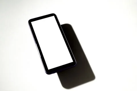 Smartphone with white screen on top of gray table. Cell phone concept. White  Stock Photos