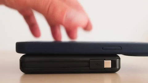 Smartphone with wireless charging. Close-up of a mobile phone charging Stock Footage 330195258