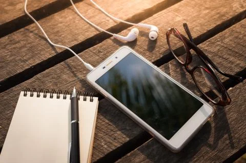 Smartphone on wood table Stock Photos
