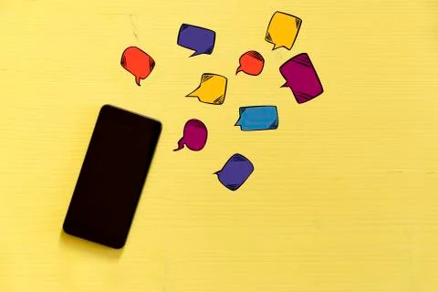 Smartphone on yellow background with text bubbles around. Messaging, texting Stock Photos