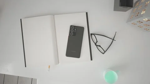 Smartphones placed on a notebook. Top view camera. Stock Footage 147862426