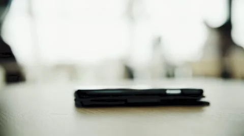 Smartpone put on the wooden table with copy space in the coffee shop HD Video stock 64949455