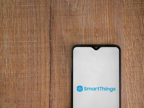 Smartthings app launch screen on smartphone on wooden background Stock Photos