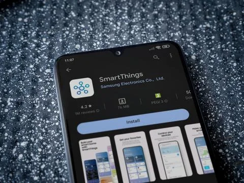 Smartthings app play store page on smartphone on a metallic background Stock Photos