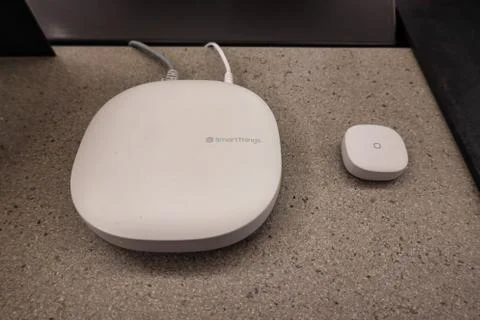 A SmartThings Hub and button on display at an Amazon Bookstore. SmartThings l Stock Photos