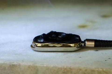 Smartwatch after fire lies on surface with damaged device casing Photos