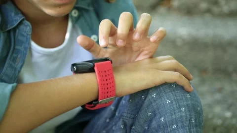 Smartwatch, Child Using Talking to Smart Watch Outdoor in Park, Kid Girl Playing Stock-Footage 346678788