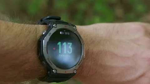 Smartwatch displaying fat burning zone heart rate 117 bpm on a male wrist Stock Footage 346073079