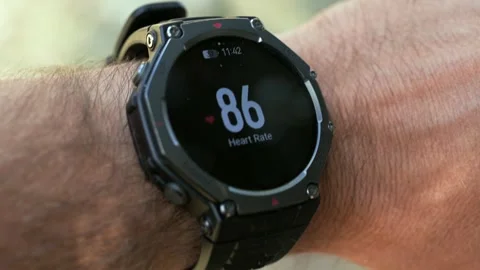Smartwatch displaying heart rate pulse measurement on a man's wrist Stock Footage 346071867