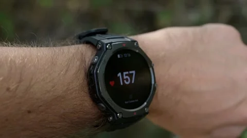 Smartwatch displaying high heart rate pulse during intense workout on male wrist Stock Footage 346072360