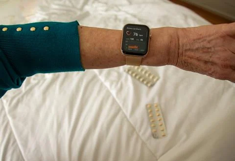 Smartwatch tracks health data while resting on bed Stock Photos