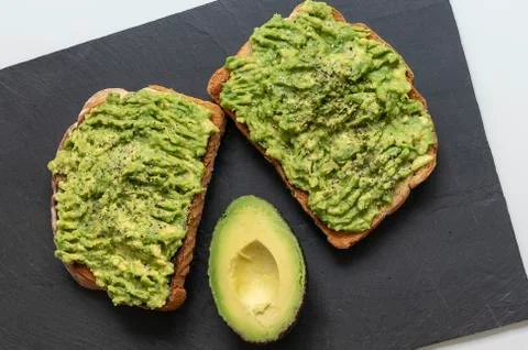 Smashed avocado and black pepper toast Stock Photos