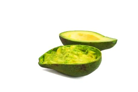 Smashed Avocado Halves on a White Background with Fresh Texture Stock Photos