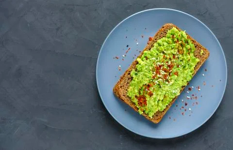 Smashed avocado toast with chilli and copy space Stock Photos