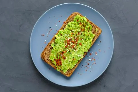 Smashed avocado toast with chilli and copy space Stock Photos