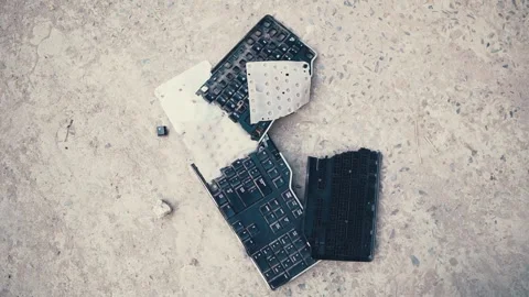 Smashed keyboard - shattered keyboard - broken keyboard on concrete ground Stock Footage 138784150