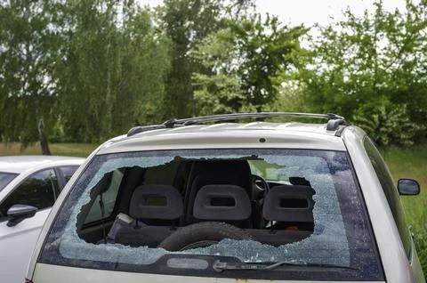 A smashed rear window of a parked car Stock Photos