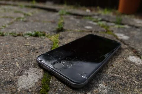 Smashed screen iPhone 6s on concrete Stock Photos