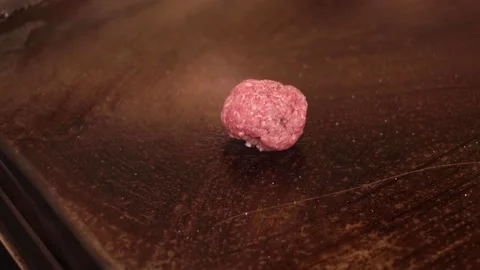 Smashing raw beef on grill Stock Footage 133201804