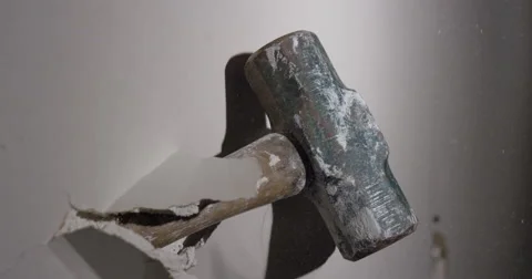 Smashing through Drywall in slow motion - sledge hammer Stock Footage 62765788
