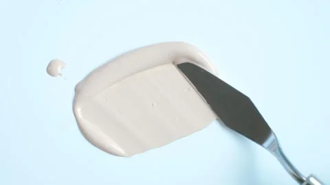 Smear of beige base for makeup or concealer on white background made with a Stock Footage 274783192