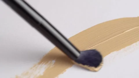 A smear of foundation cream or concealer with a brush on a white background.. Stock Footage 250598917