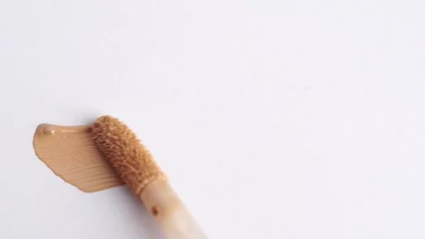 A smear of foundation cream or concealer with a brush on a white background.. Stock Footage 263192149