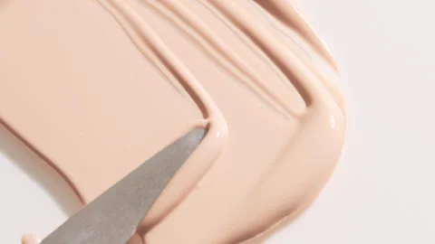 Smear foundation face make-up cream or beige concealer smudge Stock Footage 328984634