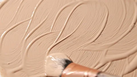 Smear foundation or beige concealer smudge with cosmetic brush. Stock Footage 171242786