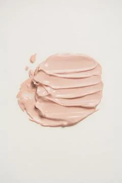 A smear of liquid foundation on a light background Stock Photos