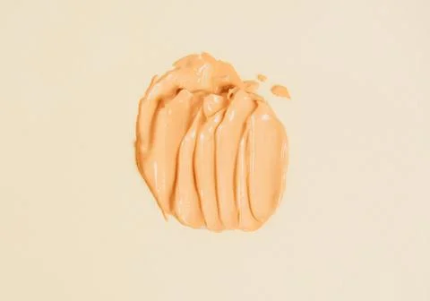 A smear of liquid foundation on a light background Stock Photos