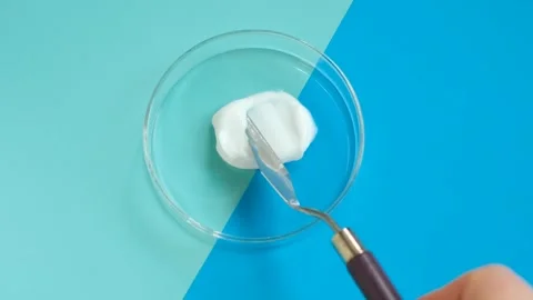 Smear of moisturizing cream on blue background close-up. Stock Footage 299555932