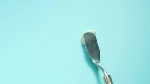 Smear of moisturizing cream on blue background close-up. Stock Footage 329662590