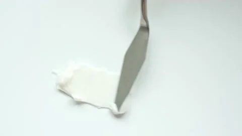 Smear of moisturizing cream made with a spatula on a white background top view Stock Footage 237591919