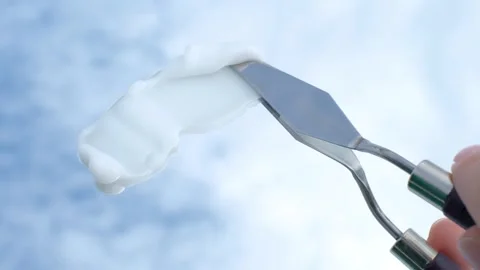 Smear of moisturizing cream made with spatula against the background of sky and Stock Footage 250227810