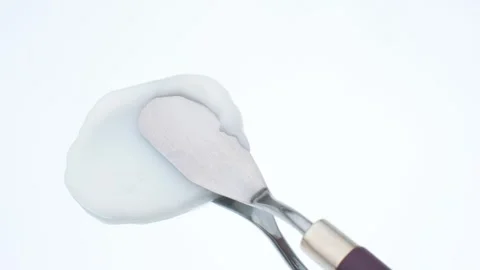 Smear of moisturizing cream made with spatula on white background, top view. Stock Footage 250738405
