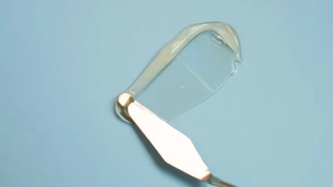 Smear of moisturizing face gel on blue background close-up. Stock Footage 299557126