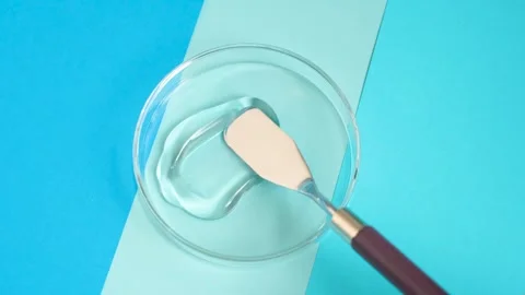 Smear of moisturizing face gel on blue background close-up. Stock Footage 299682303