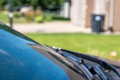 Smeared and dirty front windshield of a vehicle after hitting bugs. Stock Photos