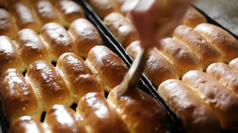 Smearing buns with glaze Stock Footage 53776203