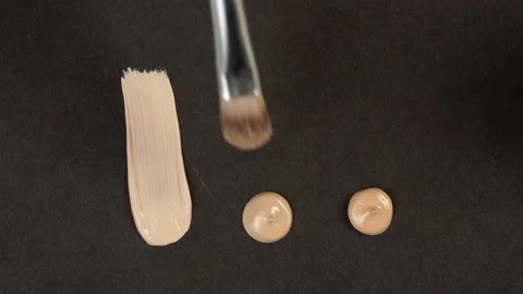 Smearing foundation tone on black background. Brown cream, concealer texture Stock Footage 166180591