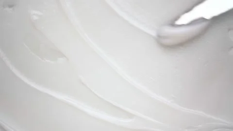 Smearing soft cream over smooth surface with metal spatula 動画素材 170358145