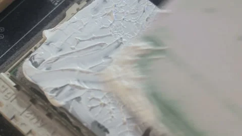 Smearing thermal paste on the CPU. Stock Footage 122992605