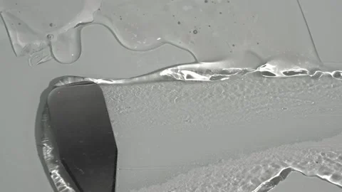 Smearing transparent gel on a white surface Stock Footage 252195480