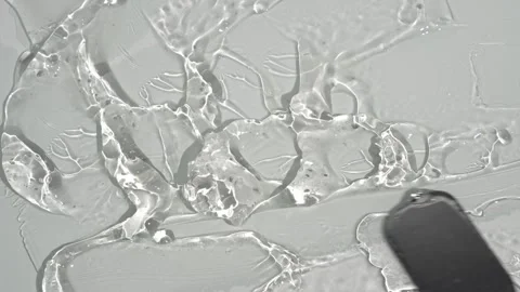 Smearing transparent gel on a white surface Stock Footage 252195506
