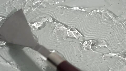 Smearing transparent gel on a white surface Stock Footage 252195584